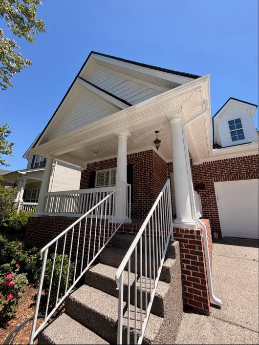 Freshly painted home exterior — porch columns, soffits and trim in crisp white